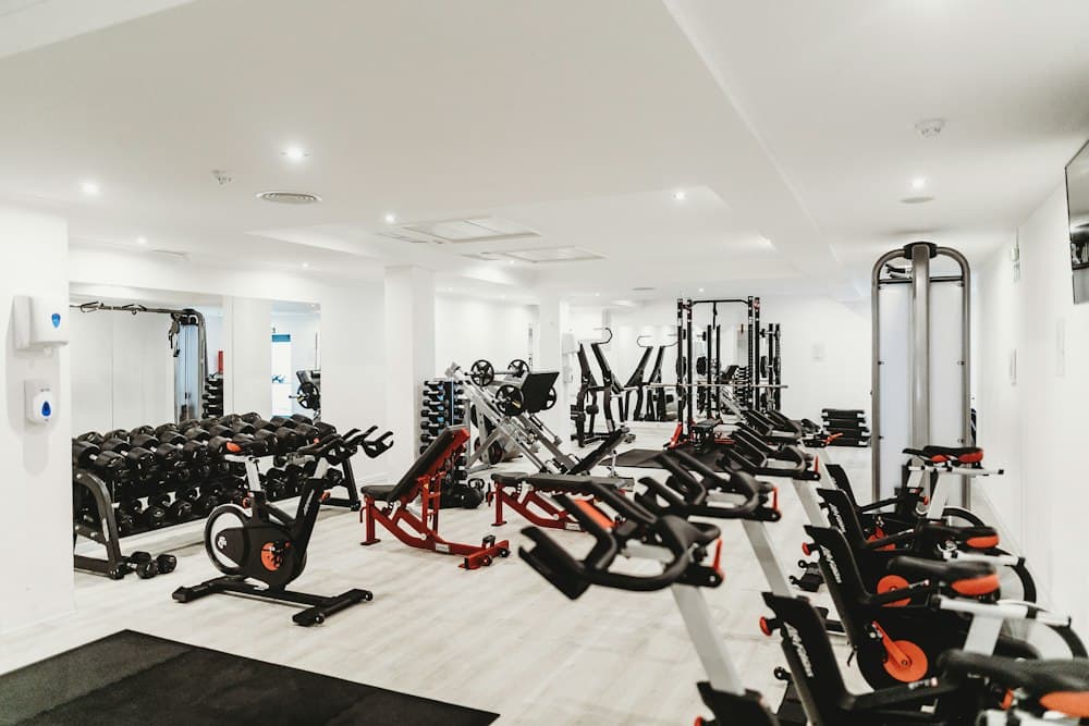 Exercise bikes and weight machines in a bright gym